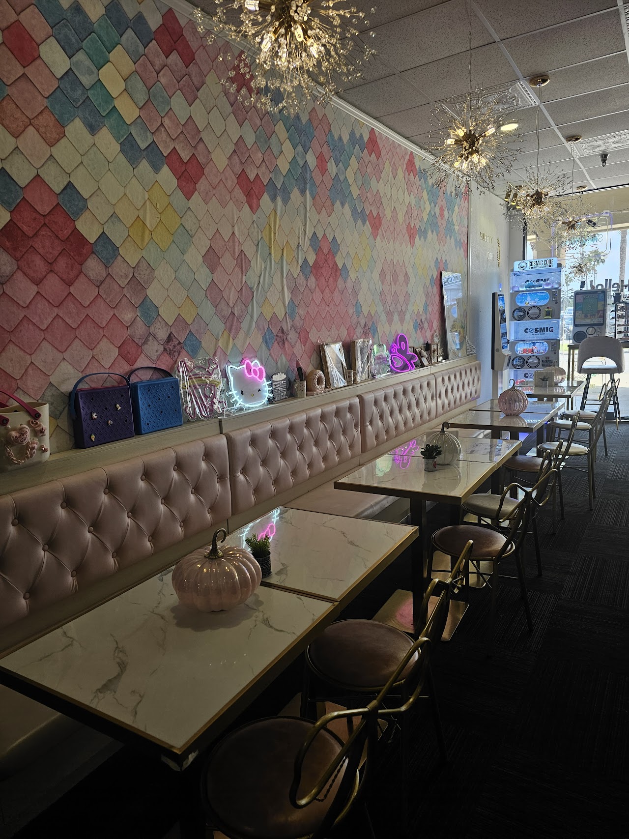 Sweety Cafe dining area with pastel booths and gold accents